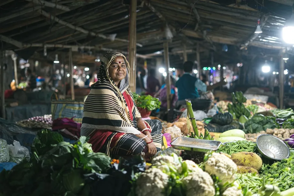 A woman selling vegetables in a wholesale market