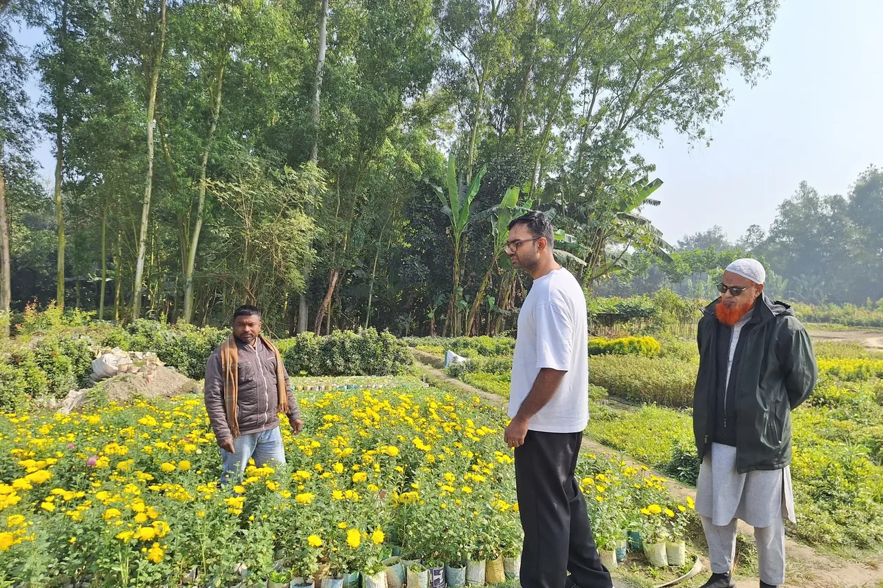 Cultivera team members speaking with a producer during a field visit in Bogra