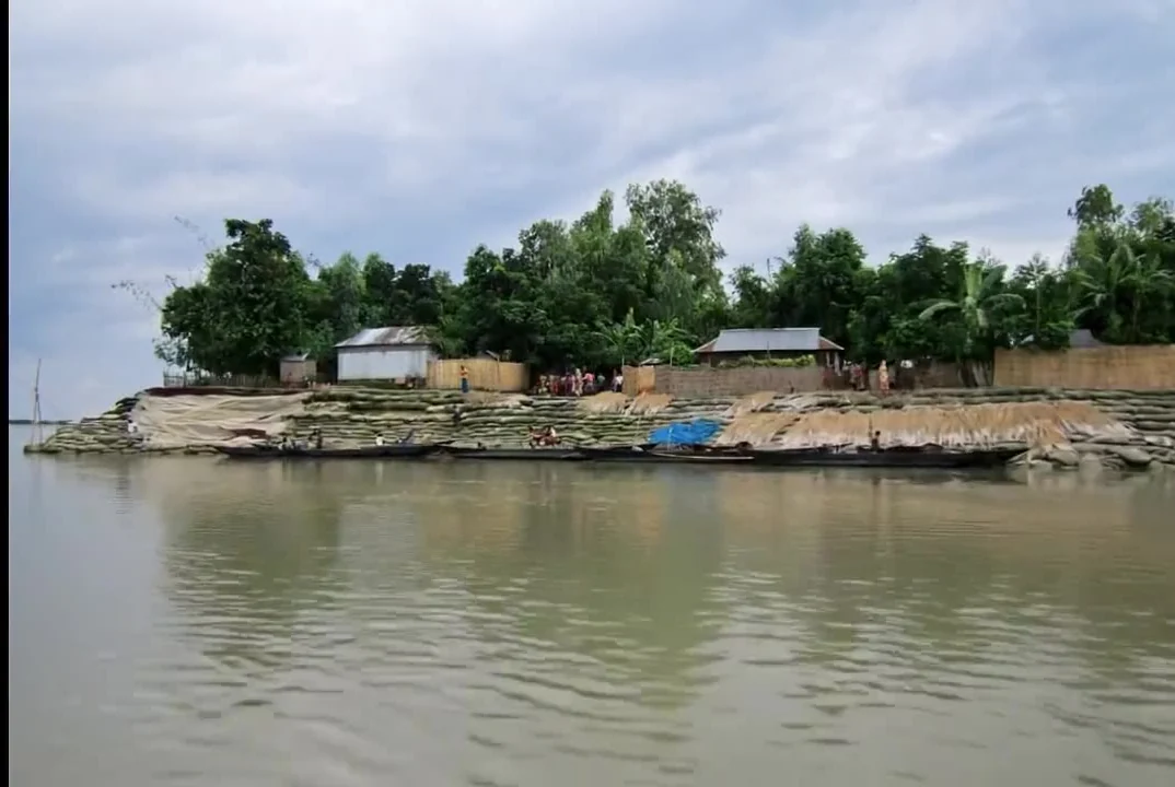 A river-island settlement beside open water in Bangladesh