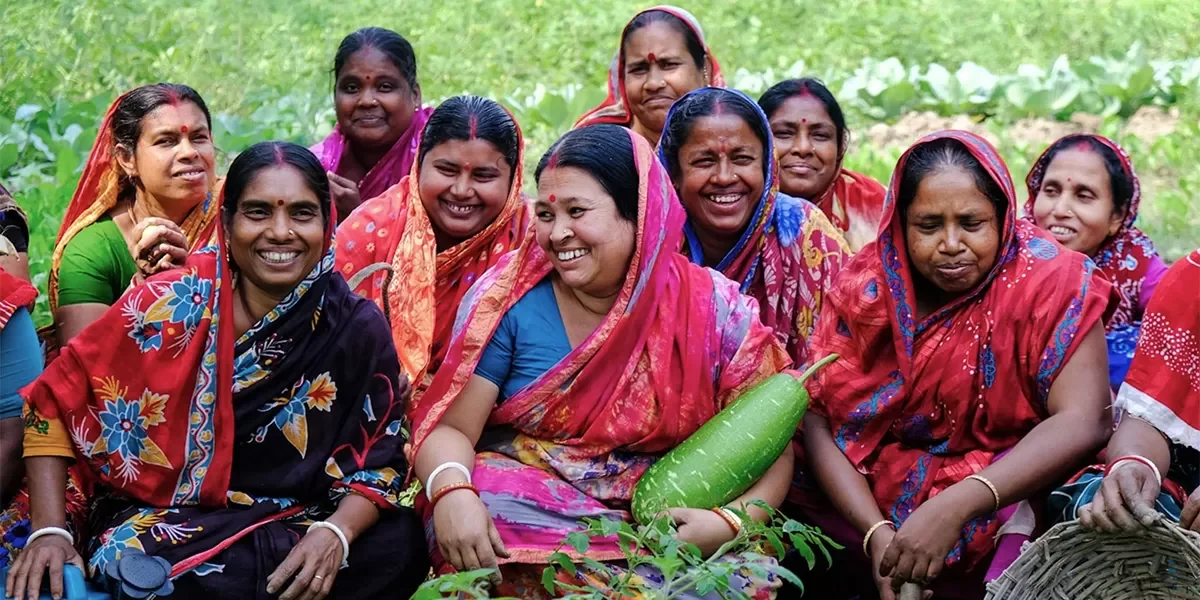 Women gathered around harvested produce in rural Bangladesh