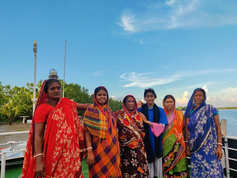 Women standing together on a river boat in Bangladesh